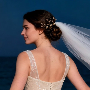 Détail d'épingle à cheveux feuille avec perles et zircons sur mariée avec voile blanc
