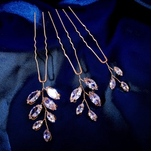 Three-piece gold leaf hair pins set with sparkling zircon crystals on blue satin