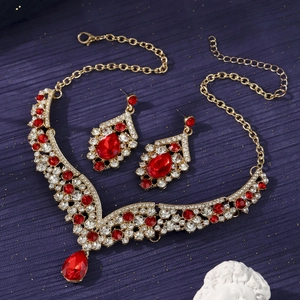 Luxury gold necklace set with red teardrop gemstones and diamonds for gala events