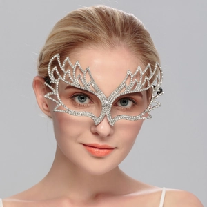 Detail of silver masquerade mask with sparkling rhinestones and elegant wing design