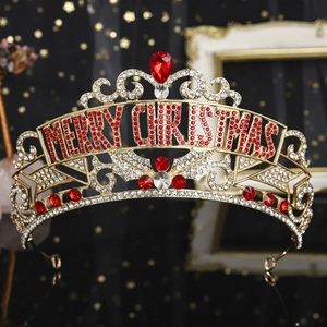 Macro detail of Merry Christmas crown with red teardrop gem and sparkling rhinestones