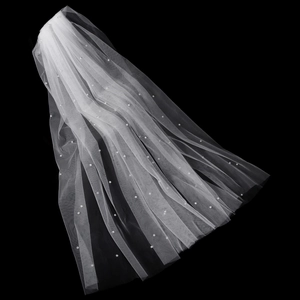 Vista dettagliata del velo da sposa lungo bianco con perle cucite a mano su morbido tulle