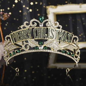 Detail of gold Christmas crown with Merry Christmas text and green crystal stones