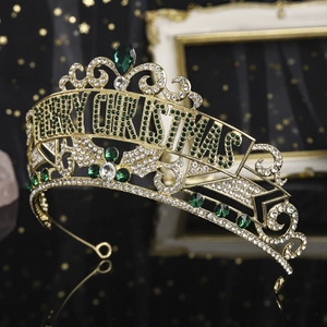 Detailed close-up of golden Christmas crown featuring green crystals and Merry Christmas text