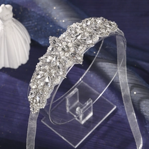 Macro detail of silver bridal headband with sparkling rhinestones and white pearls