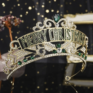 Detail of gold Merry Christmas crown with green and white rhinestones on dark background