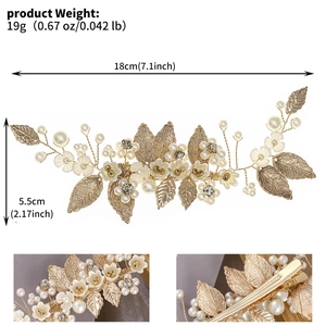 Close-up of golden leaf hair clip with pearls and rhinestones for bridal hairstyle