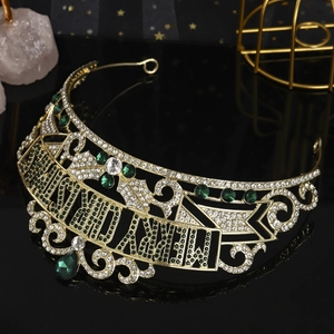 Detailed macro view of Merry Christmas lettering on gold crown with green rhinestones