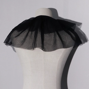Macro shot of tiered black mesh ruffles on a vintage style clown neck collar accessory
