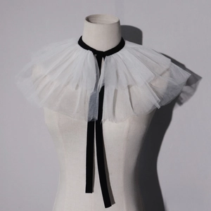 Detail of white ruffled tulle clown collar with black velvet neck tie for stage costume