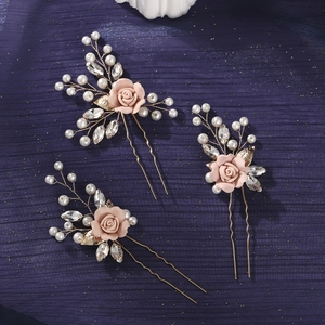 Detail of three handmade floral hair pins with pink roses, pearls, and crystals on gold wire