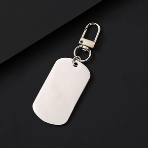 Macro view of rectangular stainless steel dog tag keychain with brushed silver finish