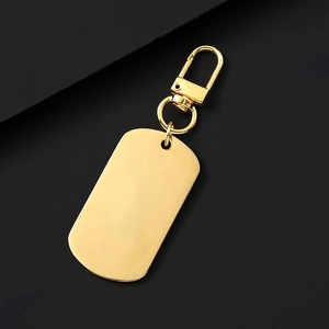 Golden stainless steel rectangle tag keychain with lobster clasp on black background