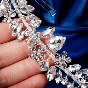 Detail of silver bridal headband with marquise and teardrop crystals on blue satin