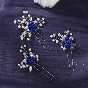 Detailed close-up of blue clay flower hair pins with pearls and crystals set on silver wire