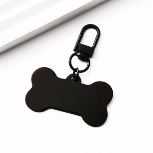 Detailed view of bone-shaped black metal pet tag with a secure lobster clasp attachment