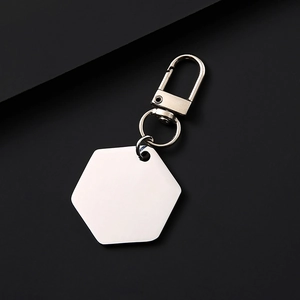 Macro shot of a minimalist hexagonal brushed metal keychain with a silver lobster clasp