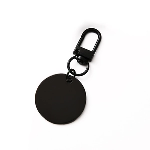 Black circular stainless steel keychain with spring-loaded carabiner clip for DIY engraving