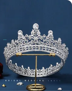 Detailed view of bridal silver alloy tiara with sparkling rhinestones on display stand