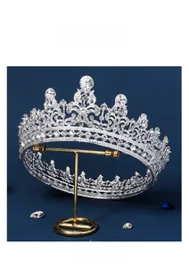 Silver bridal wedding tiara with sparkling rhinestones displayed on a jewelry stand