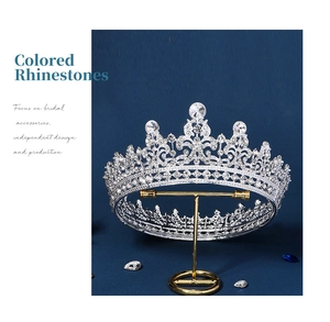 Detailed close-up of a silver bridal tiara with rhinestones on a display stand