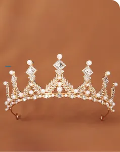Detailed macro view of vintage gold crown featuring elegant white pearls and rhinestones