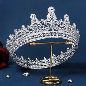 Elegant silver bridal tiara with sparkling rhinestones on a blue velvet backdrop