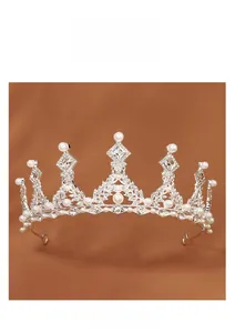 Detail of silver alloy crown with sparkling white rhinestones and elegant pearls