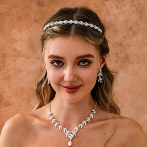 Macro detail of silver bridal jewelry set with sparkling rhinestones and teardrop pendant