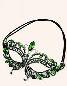 Detail of silver alloy butterfly mask with sparkling dark green rhinestones on white background