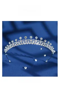 Detail of silver bridal tiara with sparkling rhinestones on elegant blue silk fabric