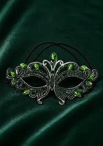 Close-up of luxury butterfly masquerade mask with green rhinestones and silver metal