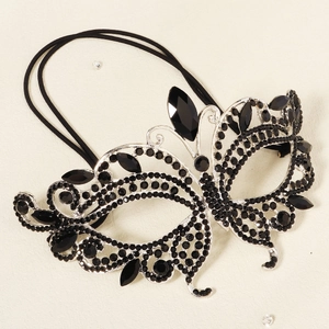 Detail of silver butterfly masquerade mask featuring intricate black rhinestone wings