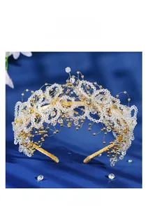 Detail shot of handcrafted crystal and pearl beads on a golden bridal headband