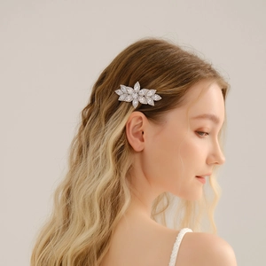 Elegant floral silver hair clip with zircon crystals on model with blonde hair