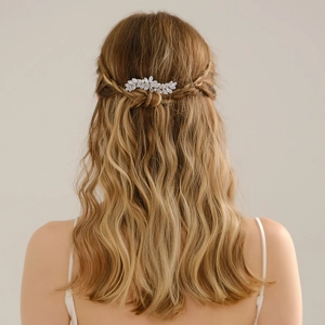 Elegant silver leaf hair clip with clear crystals worn on wavy blonde hair for wedding style