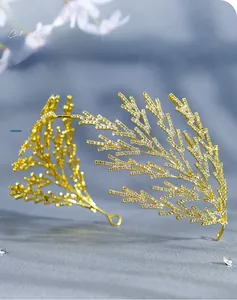 Detailed macro shot of the golden rhinestone crown with intricate leaf branch design