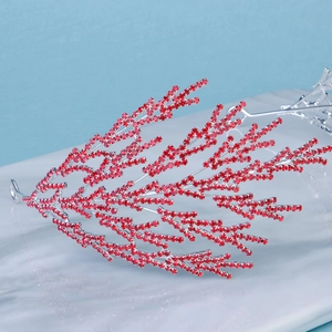 Detailed macro view of coral-shaped luxury bridal headband with sparkling red rhinestones