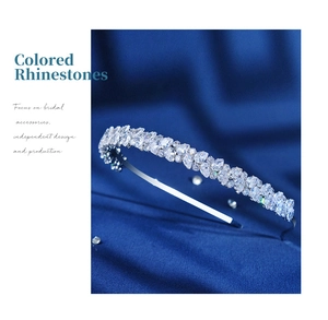 Detailed view of luxury silver tiara with teardrop and round zircons on blue silk