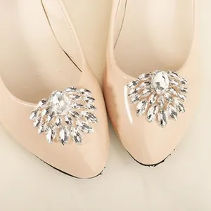 Close-up of sparkling rhinestone crystal clip on beige patent leather flat shoe toe