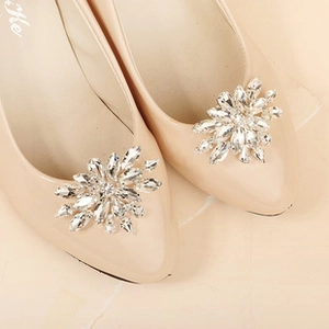 Macro shot of sparkling sunflower rhinestone shoe clips on pointed toe high heels