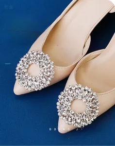 Close-up of sparkling rhinestone shoe buckles on beige high heels for bridal wedding
