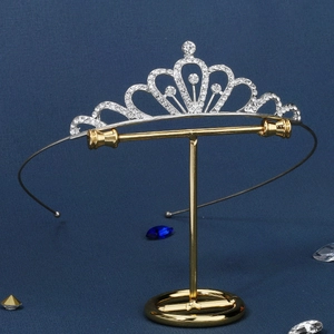 Detailed macro view of silver tiara featuring heart curves and inlaid white rhinestones