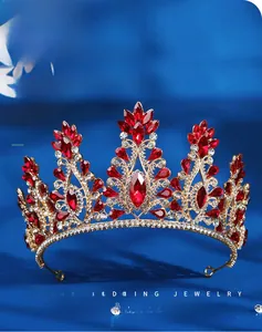Close-up of luxury bridal tiara with red rubies and crystals on blue velvet