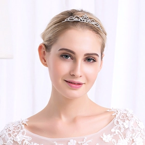 Close-up detail of silver crystal tiara on a girl, showing sparkling rhinestones and alloy design