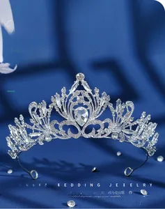 Close-up of a silver bridal tiara with sparkling crystal flower motifs and a teardrop diamond
