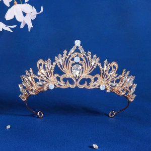 Detail of a vintage golden bridal crown with clear rhinestones and light blue opals