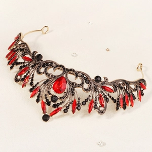 Detail of vintage Baroque bridal crown with red crystals and black rhinestones on gold alloy
