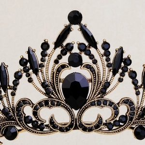 Macro detail of gothic gold bridal crown featuring filigree patterns and black crystals