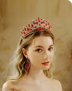 Detailed view of luxury bridal tiara and matching earrings with red rhinestones
